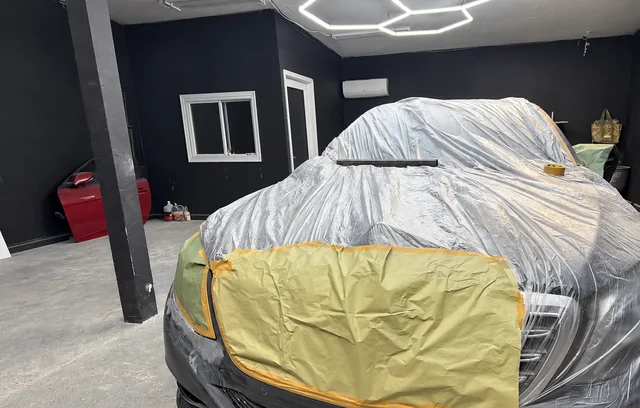 Front of a vehicle masked for paint preparation at M&A