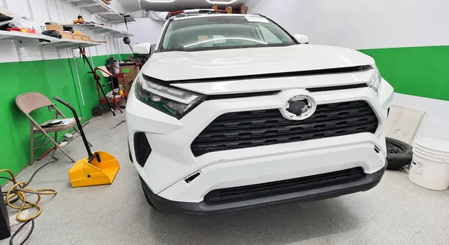 White SUV front end during repair at the M&A workshop