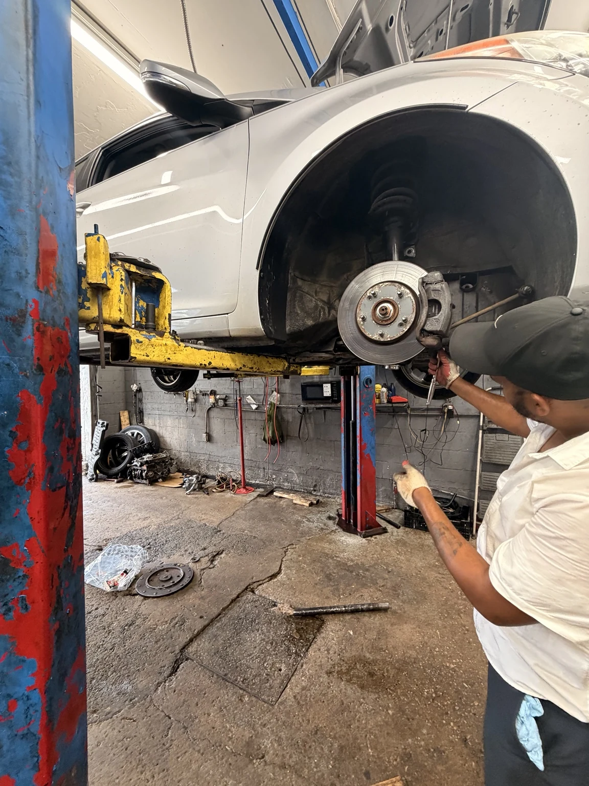 Technician working on a vehicle brake assembly