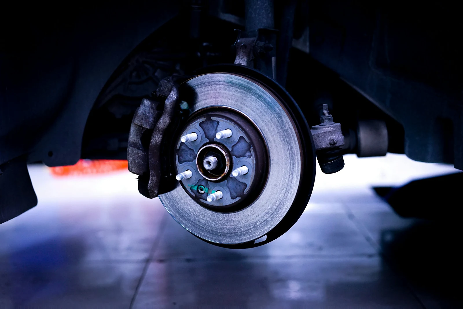 Exposed brake rotor and caliper with the wheel removed.