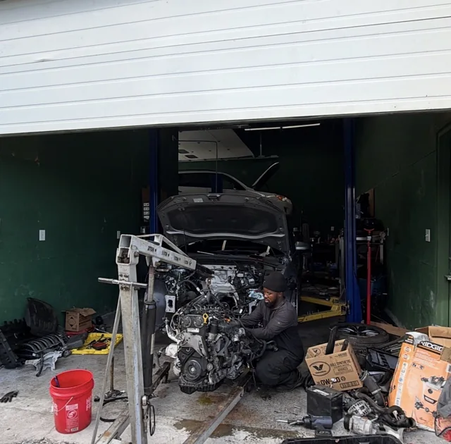 M&A team member working beside an engine